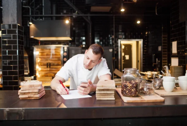 Chef taking notes at a restaurant | Surviving the January Dip: 6 Q4 Decisions That Protect Your First Quarter of 2027